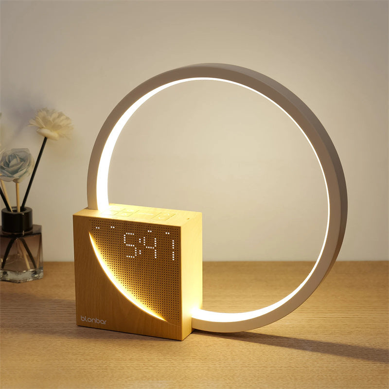 Modern LED bedside lamp with wooden base, circular light ring, and digital alarm clock showing nature sounds and sunrise simulation.