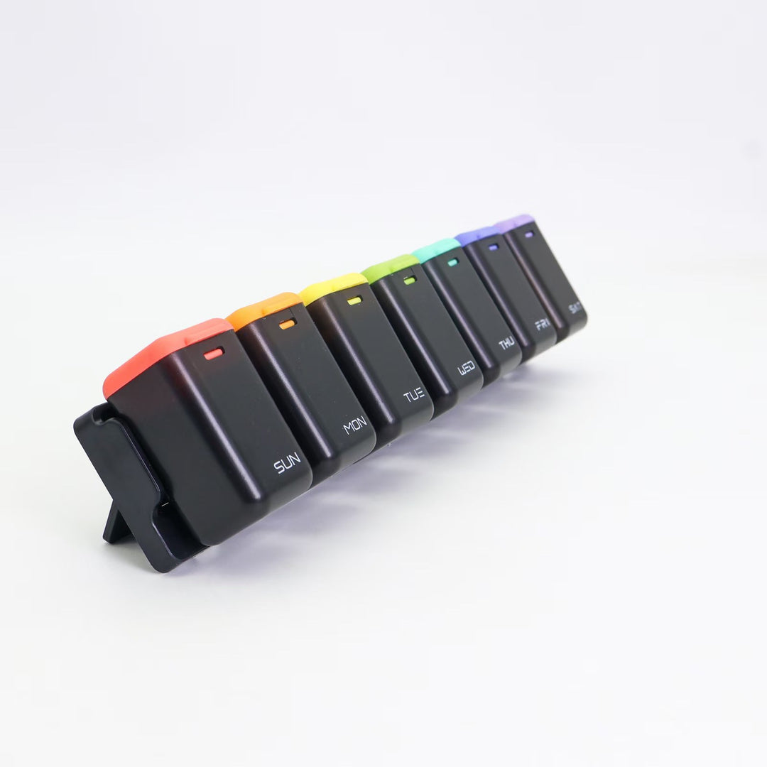 7-day magnetic pill organizer with large labeled compartments for vitamins, supplements, and capsules, shown with measurements and daily labels from SUN to SAT.
