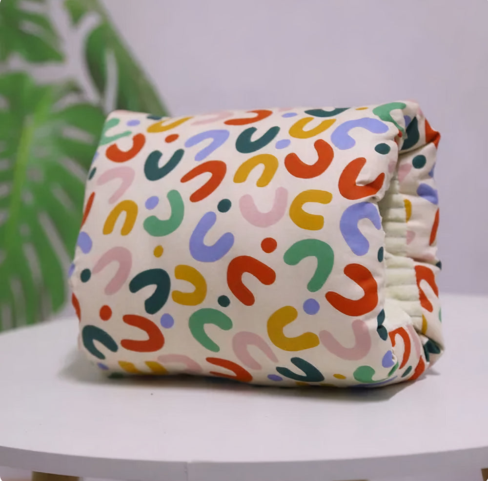 Mom&Baby™ Nursing Arm Pillow with colorful abstract print, featuring bold, playful shapes in red, green, blue, yellow, and pink, perfect for comfortable and enjoyable feeding sessions.